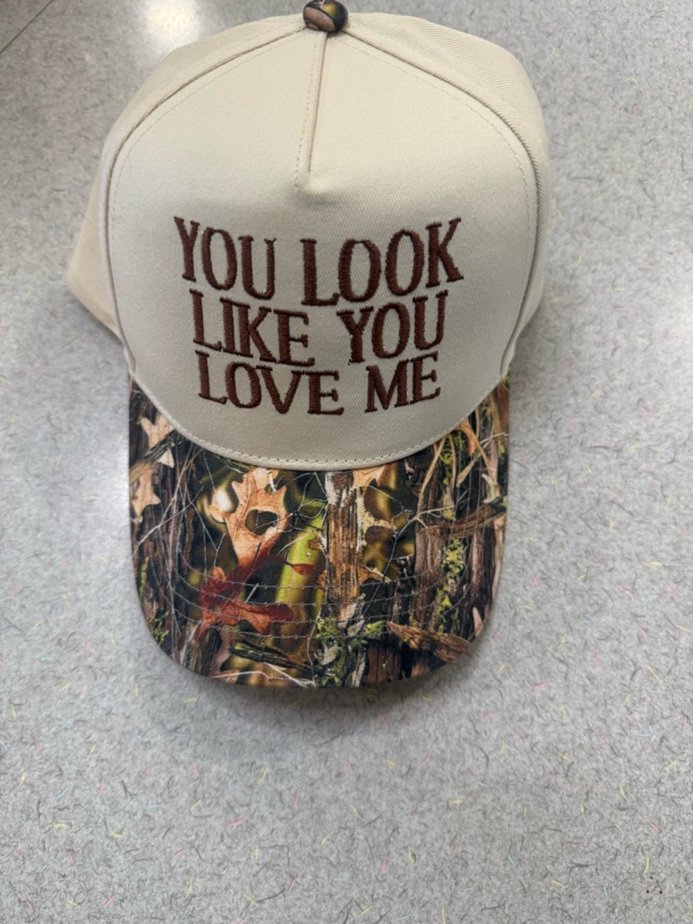 Embroidered Slogan Trucker Hat in Beige with Camo Bill